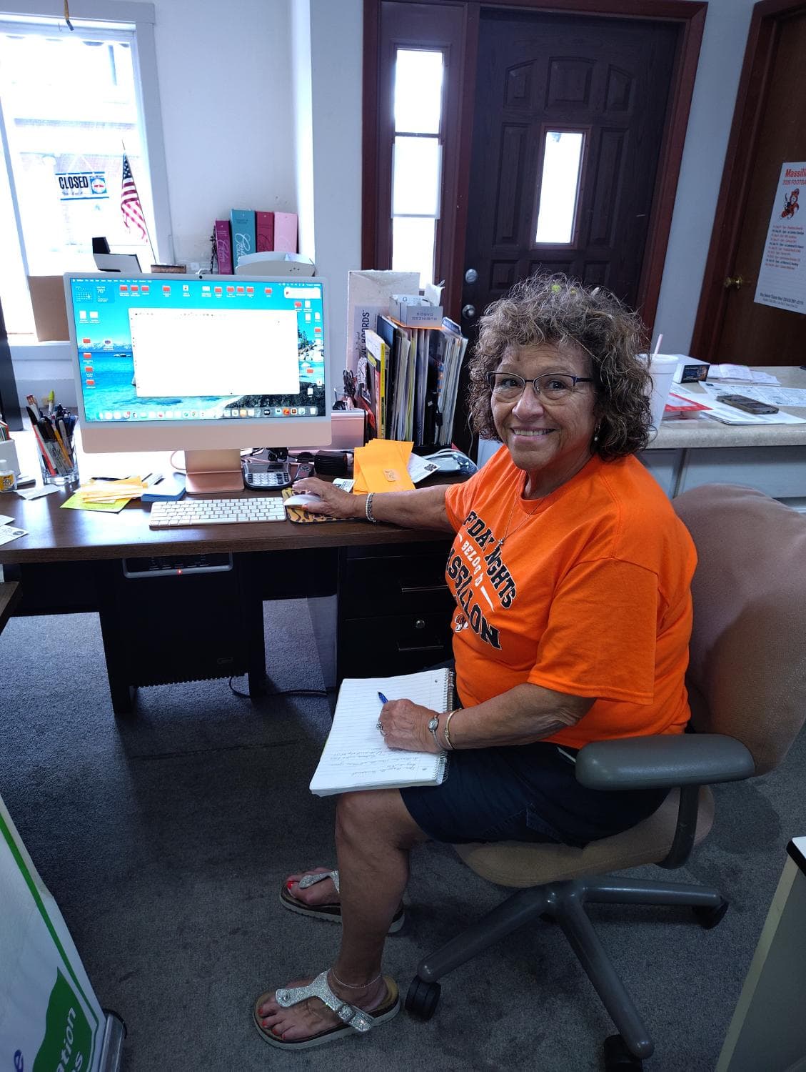 Sarita Cunningham at the shop desk, ready to take a print order